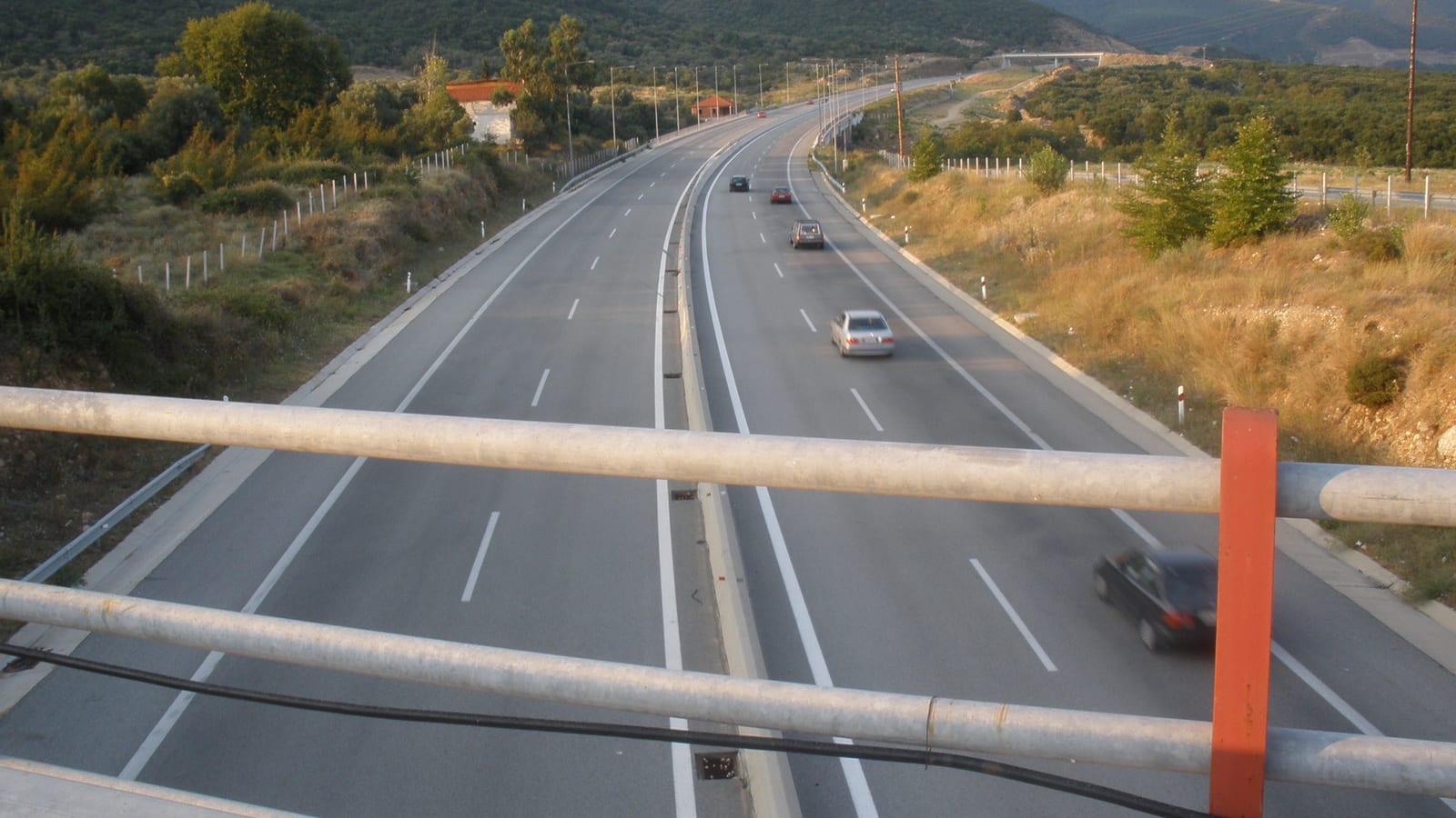Η Εγνατία Οδός κοντά στην Ασπροβάλτα, με αυτοκίνητα στον αυτοκινητόδρομο και βουνά στο βάθος